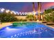 Backyard pool with lights, lush landscaping and tiled edging, perfect for relaxation at 2040 E Indigo Brush Rd, Phoenix, AZ 85048