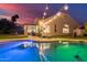 Gorgeous pool and patio with outdoor seating area, artificial grass, and ambient lighting at 2040 E Indigo Brush Rd, Phoenix, AZ 85048