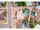 This aerial view showcases a home with solar panels and a private pool, surrounded by lush landscaping and neighboring properties at 2148 E Cairo Dr, Tempe, AZ 85282