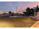 A backyard featuring a large pool, artificial grass, and privacy landscaping, perfect for outdoor enjoyment at 2148 E Cairo Dr, Tempe, AZ 85282