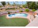 A spacious backyard with an in-ground pool, artificial grass, and an outdoor entertaining area, perfect for hosting gatherings at 2148 E Cairo Dr, Tempe, AZ 85282