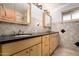 This bathroom features a double sink vanity with mirror, lighting and tile surround at 2148 E Cairo Dr, Tempe, AZ 85282