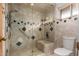 This bathroom has a glass enclosed shower with built-in bench, handrails, tile surround, and toilet at 2148 E Cairo Dr, Tempe, AZ 85282