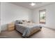 Bright bedroom featuring neutral walls, light carpet, window, ceiling fan, and platform bed at 2148 E Cairo Dr, Tempe, AZ 85282