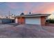 Spacious garage with solar panels, a convenient side entrance, and ample parking space in a well-kept setting at 2148 E Cairo Dr, Tempe, AZ 85282