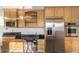 This kitchen features stainless appliances, granite counters and light wood cabinets at 2148 E Cairo Dr, Tempe, AZ 85282