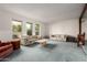 Spacious living room with plush carpeting, bright windows, and comfortable floral sofas at 2148 E Cairo Dr, Tempe, AZ 85282