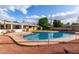 A refreshing pool with a spacious patio and outdoor seating, surrounded by lush landscaping and a cozy house at 2148 E Cairo Dr, Tempe, AZ 85282