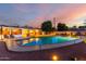 An inviting pool featuring a spacious patio with lounge chairs, set amidst a serene backyard and a sunset sky at 2148 E Cairo Dr, Tempe, AZ 85282