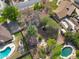 Overhead view of residential properties with pools and tree-filled yards in a neighborhood setting at 222 N Miller St, Mesa, AZ 85203