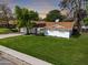 Beautiful home with a large green lawn, complimented by mature shade trees and a well-maintained exterior at 222 N Miller St, Mesa, AZ 85203