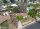 Aerial view of home with pool, mature trees, and adjacent neighborhood at 222 N Miller St, Mesa, AZ 85203