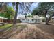 Large backyard with brick patio area and lush tree canopy, perfect for outdoor activities at 222 N Miller St, Mesa, AZ 85203