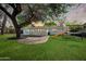Spacious backyard with a lush lawn, a brick patio area, and a playful slide for outdoor enjoyment at 222 N Miller St, Mesa, AZ 85203