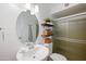 Bathroom featuring an oval mirror, plants for decor, and sliding shower door at 222 N Miller St, Mesa, AZ 85203