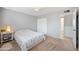 Bright bedroom featuring carpet floors, closet, and ensuite bathroom access at 222 N Miller St, Mesa, AZ 85203
