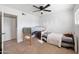 Bedroom featuring two beds, a ceiling fan and a closet with a sliding door at 222 N Miller St, Mesa, AZ 85203