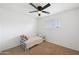 Cozy bedroom featuring a ceiling fan and plantation shutters for natural light control at 222 N Miller St, Mesa, AZ 85203