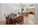 Open-concept dining area that flows into the kitchen and living room with matching hardwood floors at 222 N Miller St, Mesa, AZ 85203