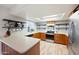 Bright kitchen featuring wood cabinets, a stainless steel oven, and floating shelves for stylish storage and decor at 222 N Miller St, Mesa, AZ 85203