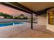 Back patio view of pool and backyard area with neutral colored sky at 226 W Ranch Rd, Tempe, AZ 85284