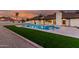 Beautiful backyard featuring a sparkling pool and lush green artificial grass at 226 W Ranch Rd, Tempe, AZ 85284