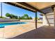 Inviting pool with stone deck is viewed from covered patio area for relaxing outdoor living at 226 W Ranch Rd, Tempe, AZ 85284