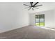Bright, carpeted bedroom features private backyard access via sliding glass door at 226 W Ranch Rd, Tempe, AZ 85284