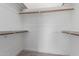 Bright, empty walk-in closet with carpet and wooden clothes rods on multiple levels at 226 W Ranch Rd, Tempe, AZ 85284