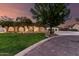 Charming single-story home featuring mature trees, a manicured lawn, and an expansive driveway at 226 W Ranch Rd, Tempe, AZ 85284