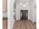 Bright foyer with wood flooring, a modern chandelier, and a glimpse into the dining area at 226 W Ranch Rd, Tempe, AZ 85284