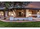 Inviting front porch with stylish lanterns, decorative brickwork, colorful plants and a cozy bench at 226 W Ranch Rd, Tempe, AZ 85284