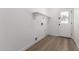 Clean, spacious laundry room with laminate flooring and a door with a window at 226 W Ranch Rd, Tempe, AZ 85284