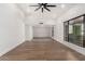 Spacious living room featuring wood-look flooring, a large window, and neutral paint at 226 W Ranch Rd, Tempe, AZ 85284