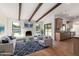 Open-concept living area featuring a fireplace, exposed beam ceiling, and access to the pool area at 226 W Ranch Rd, Tempe, AZ 85284