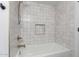 A close-up of a stylish bathtub with a showerhead and niche featuring white tile at 226 W Ranch Rd, Tempe, AZ 85284