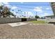 Spacious backyard featuring rock landscaping, a patch of grass, tall palm trees, and a block fence at 23 W Fairmont Dr, Tempe, AZ 85282