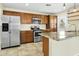 Updated kitchen with stainless steel appliances, granite countertops, and open access to adjacent rooms at 23 W Fairmont Dr, Tempe, AZ 85282