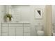 Bright, white bathroom featuring a modern vanity, framed mirror, and a shower-tub combo at 23225 W Marguerite Ave, Buckeye, AZ 85326