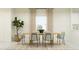 Bright dining room with a natural wood table, comfortable seating, and a large window with natural light at 23225 W Marguerite Ave, Buckeye, AZ 85326