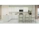 Modern kitchen with white cabinetry, stainless steel appliances, and a breakfast bar with seating for casual dining at 23225 W Marguerite Ave, Buckeye, AZ 85326