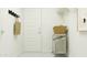 Functional mud room with coat hooks, storage baskets, and a convenient trolley for organized living at 23225 W Marguerite Ave, Buckeye, AZ 85326