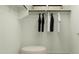 Spacious walk-in closet with hanging rods, shelving, and a comfortable ottoman for organized storage and convenience at 23225 W Marguerite Ave, Buckeye, AZ 85326
