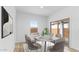 A modern dining area with stylish chairs, marble table, and natural lighting at 23403 W Albeniz Pl, Buckeye, AZ 85326