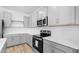 Modern kitchen with gray cabinetry, stainless steel appliances and white countertops at 23403 W Albeniz Pl, Buckeye, AZ 85326