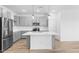 Modern kitchen featuring stainless steel appliances and a center island with pendant lighting at 23403 W Albeniz Pl, Buckeye, AZ 85326