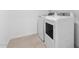 Convenient laundry area with modern, full-size, white washer and dryer at 23403 W Albeniz Pl, Buckeye, AZ 85326