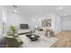 Spacious living room with ample seating, light wood floors and plenty of natural light at 23403 W Albeniz Pl, Buckeye, AZ 85326