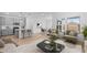 Bright living room features an open floor plan with a modern kitchen and dining area at 23403 W Albeniz Pl, Buckeye, AZ 85326