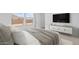 Cozy main bedroom with carpet, windows, and a stylish media console at 23403 W Albeniz Pl, Buckeye, AZ 85326